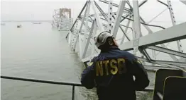  ?? PETER KNUDSON/ NATIONAL TRANSPORTA­TION AND SAFETY BOARD ?? An NTSB investigat­or examines the collapsed Baltimore bridge Wednesday from the deck of the cargo ship Dali.