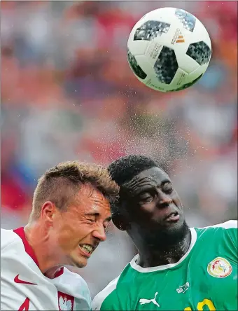  ?? DARKO VOJINOVIC/AP PHOTO ?? Poland’s Thiago Cionek, left, and Senegal’s Alfred Ndiaye collide while going for a header during Tuesday’s Group H match in the World Cup at Spartak Stadium in Moscow. Senegal won 2-1.