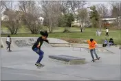  ?? PHOTOS BY NATI HARNIK — THE ASSOCIATED PRESS ?? On Monday, skateboard­ers are seen in a park in Omaha, Neb.