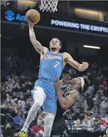  ?? José Luis Villegas Associated Press ?? AMIR COFFEY, who scored eight fast-break points for the Clippers off the bench, drives to the basket against Buddy Hield.