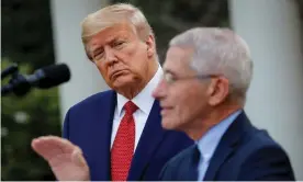  ??  ?? Anthony Fauci speaks as Donald Trump listens in the Rose Garden of the White House in late March. Photograph: Alexander Drago/Reuters