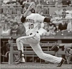  ?? Gene J. Puskar / The Associated Press ?? Pittsburgh’s Jordy Mercer hits a two-run triple during the seventh inning of Saturday’s game in Pittsburgh. The Pirates won 7-6.