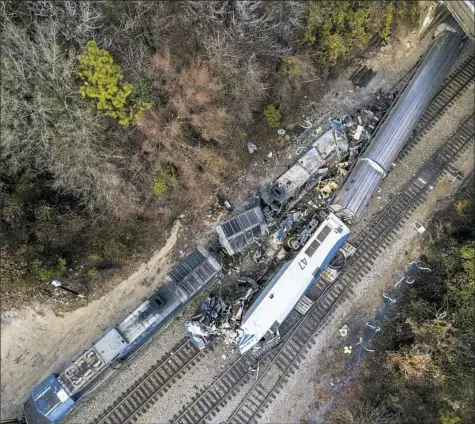  ?? AP Photo/Jeff Blake ?? An aerial view of the aftermath of a crash Sunday of an Amtrak passenger train and a CSX freight train in Cayce, S.C.