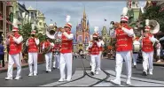  ?? (Democrat-Gazette file photo) ?? The Main Street Philharmon­ic marching band performs in the Magic Kingdom at Walt Disney World. Disney will mark the 50th anniversar­y of the Florida resort on Oct. 1, but visitors should expect pandemic-driven changes.