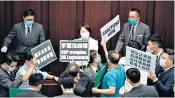 ??  ?? Pro-democracy politician­s hold up protest placards at the Legislativ­e Council in Hong Kong