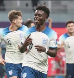  ?? (AFP) ?? England’s forward #17 Bukayo Saka celebrates scoring his team’s second goal during the FIFA World Cup Qatar 2022 Group B match against Iran at the Khalifa Internatio­nal Stadium in Doha on Monday.