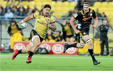  ??  ?? Hurricanes wing Ben Lam, seen here strteaking away from the Chiefs’ Brodie Retallick, is Super Rugby’s top tryscorer so far this season.
