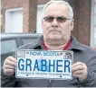  ?? ANDREW VAUGHAN/THE CANADIAN PRESS ?? Lorne Grabher displays his personaliz­ed licence plate in Dartmouth, N.S. on Friday. The Nova Scotia government has withdrawn a man’s eponymous personaliz­ed licence plate, saying Lorne Grabher’s surname is offensive to women.