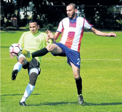  ?? BERND FRANKE/POSTMEDIA NEWS ?? A member of the Sudanese-Canadian soccer team from Hamilton, left, is defended by Niagara Region at a tournament Saturday at Pearson Park in St. Catharines.