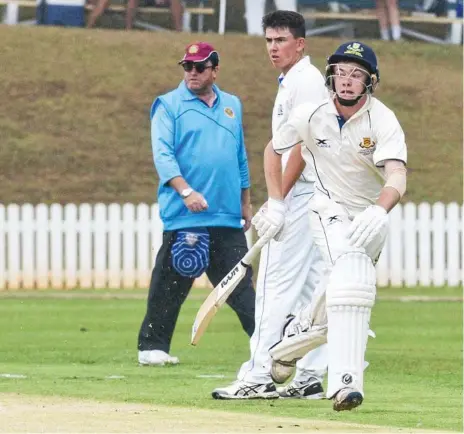  ?? Photo: Nev Madsen ?? CENTURY MAN: Mitch Doolan runs between the wickets as Nudgee College bowler Connor McFadyen looks on. Doolan went on to make 109 runs as Toowoomba Grammar secured a 128-run victory.