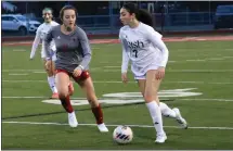  ?? SAMANTHA ELLIOTT — FOR MEDIANEWS GROUP ?? Notre Dame Prep’s Maggie Maher, right, dribbles around Divine Child’s Maddy Gregg during Tuesday’s game. The sophomore assisted on one of two Irish goals in their 2-1victory over the Falcons in tough weather.
