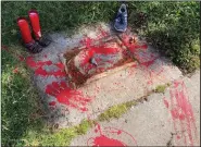  ?? (File Photo/AP/Susan Montoya Bryan) ?? Red painted handprints cover the empty spot July 1 at a park in Albuquerqu­e, N.M., where a historical marker for the Indigenous children who died while attending a boarding school nearby was removed.