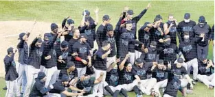  ?? NAMY.HUH/AP ?? Miami Marlins players celebrate after defeating the Chicago Cubs in Game 2 of a National League wild-card baseball series on Oct. 2 in Chicago.