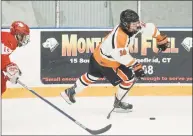  ?? Scott Mullin / For Hearst Connecticu­t Media ?? Ridgefield’s Kevin McNicholas moves the puck up ice against Greenwich on Friday in Ridgefield.