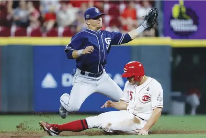  ?? AP PHOTO/JOHN MINcHIllO ?? Cincinnati Reds’ Nick Senzel (15) steals second against San Diego Padres second baseman Greg Garcia during the fifth inning of a baseball game on Tuesday in Cincinnati.