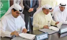  ??  ?? KUWAIT: Mazin Al-Nahedh and Salah Al-Mudhaf sign the protocol agreement.