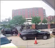  ??  ?? More than a dozen Norwalk police officers look on as state Sen. Bob Duff drives away from the Norwalk Police Department.