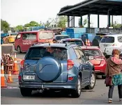  ??  ?? Two days after Christmas, before 8am, cars queue at the Hamilton Refuse Transfer Station, loaded with rubbish.