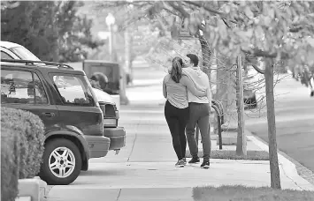  ??  ?? A couple takes a walk along S Street in the neighbourh­ood.