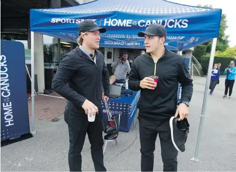  ?? JASON PAYNE ?? Canucks Brock Boeser, left, and Bo Horvat have a chat at the team’s annual charity golf tournament in Surrey on Wednesday.