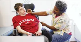  ?? MELISSA GOLDEN / THE NEW YORK TIMES ?? Personal care assistant Dorothy Trainer cares for Eric Harkins at a local ice-cream parlor in Birmingham, Ala. Harkins has cerebral palsy and a developmen­tal disability. He qualifies for 125 hours per week of help from a personal care assistant...