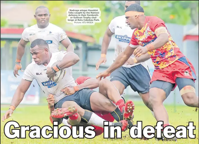  ?? Picture: ATU RASEA ?? Nadroga winger Kavekini Tabu caught by the Namosi defence in their Farebrothe­r-Sullivan Trophy challenge at Ratu Cakobau Park.