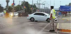  ?? Abdul Rahman/Gulf News ?? A traffic policeman on duty near the Shaikh Zayed Grand Mosque in Abu Dhabi as people arrive to offer prayers.