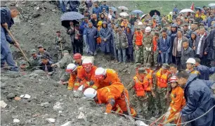  ?? AP, AFP ?? Emergency personnel and locals in search and rescue operations for survivors at the site of the massive landslide on Saturday. —