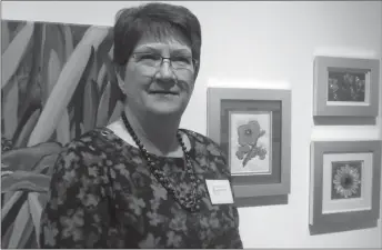  ??  ?? Local artist, Janice Wilson, shows her photograph­s, acrylic painting, and beadwork exhibits the opening reception of En Plein Air 2018.