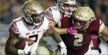  ?? MICHAEL DWYER — THE ASSOCIATED PRESS FILE ?? Florida State running back Cam Akers carries the ball as Boston College defensive end Zach Allen defends during the second half of game in Boston.
