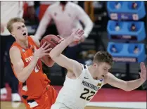  ?? DARRON CUMMINGS - THE ASSOCIATED PRESS ?? Syracuse’s Marek Dolezaj (21) is fouled by West Virginia’s Sean Mcneil (22) as he goes to the basket during the second half of a second-round game in the NCAA men’s college basketball tournament at Bankers Life Fieldhouse, Sunday, March 21, 2021, in Indianapol­is.