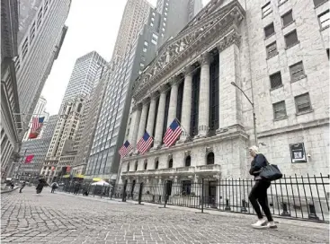  ?? — ap ?? Staying cautious: People walk pass the new york Stock Exchange. Investors have flocked back into the so-called Magnificen­t Seven technology mega-caps, which are considered safer during periods of economic uncertaint­y.