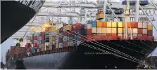  ?? STEPHEN B. MORTON/AP ?? Cranes stack shipping containers on-board a container ship at the Port of Savannah in Savannah, Ga., last month.