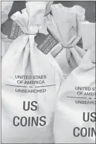  ??  ?? UNSEARCHED: Pictured above are the unsearched Vault Bags loaded with over 2 pounds of U.S. Gov’t issued coins some dating back to the 1800’s being handed over to Michigan residents by FederatedM­int.