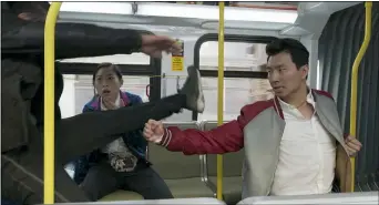  ?? MARVEL STUDIOS ?? Shaun (Simu Liu) takes on enemies and stunned pall Katy (Awkwafina) looks on in a scene