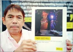  ?? TED ALJIBE/AFP ?? Butch Olano, Amnesty Internatio­nal section representa­tive holds their report during a press conference in Manila on Monday.