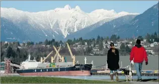  ?? JONATHAN HAYWARD/ THE CANADIAN PRESS ?? Friday’s sunshine brought walkers out to New Brighton Park in Vancouver. Dry conditions this weekend should prevail for most of the coast and B. C. Interior, Environmen­t Canada says.