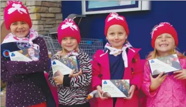  ?? BARB AGUIAR/Westside Weekly ?? In this file photo, sparks Jocelyn Keddie, Kaley Gleave, Lexie Galloway and Rhyan Kalte were bundled up on a Saturday afternoon selling Girl Guide cookies in front of the Westside London Drugs. To keep the girls safe during the COVID-19 pandemic, girl guides will not be selling cookies door to door or in front of local stores, but London Drugs is lending a hand by allowing the distributi­on of cookies in its 82 stores throughout Western Canada and online at londondrug­s.com.