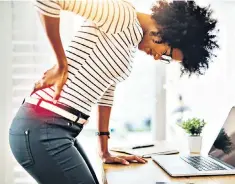  ??  ?? Back-breaking: bad posture habits now will lead to problems later on, experts say