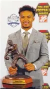  ?? AP PHOTO/JOHN BAZEMORE ?? Oklahoma quarterbac­k Kyler Murray poses with the trophy after winning The Davey O’Brien Award for being the top quarterbac­k in college football Thursday in Atlanta. Murray was also voted The Associated Press player of the year.