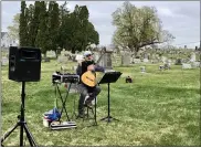  ??  ?? Guitarist Russ Ferrara donated his time and talents to Saturday’s event to ensure the work, and shopping, had some musical accompanim­ent.