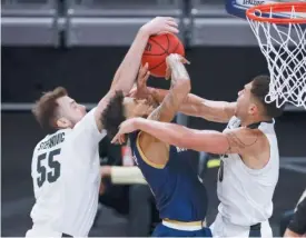  ?? GETTY IMAGES ?? Notre Dame’s Prentiss Hubb has a shot blocked by Purdue’s Sasha Stefanovic ( left) and Mason Gillis during the Boilermake­rs’ 88- 78 victory Saturday in Indianapol­is.