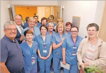  ??  ?? Mr Tait with volunteers and nursing staff who are ready to welcome patients into the new unit.