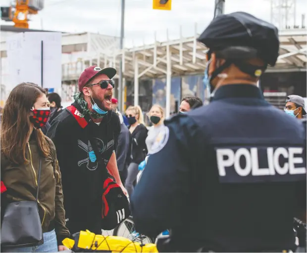  ?? CARLOS OSORIO / REUTERS FILES ?? A man screams at police as protesters march to highlight the deaths in the U. S. of Ahmaud Arbery, Breonna Taylor and George Floyd, and of Toronto’s Regis Korchinski-paquet. A survey has found that police presence makes many feel less secure about their safety.