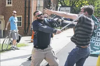  ?? Chip Somodevill­a/Getty Images ?? White nationalis­ts, neo-Nazis and members of the “alt-right” clash with counter-protesters in the street after the “Unite the Right” rally was delcared an unlawful gathering by Virginia State Police on Saturday in Charlottes­ville, Va.