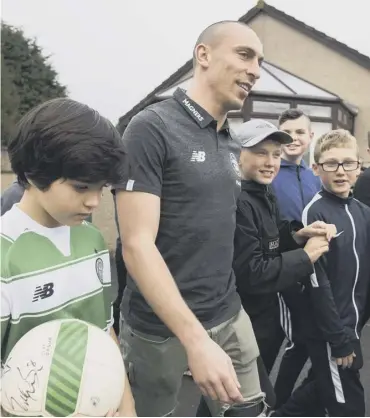  ??  ?? 0 Scott Brown is greeted by local youngsters i n Cardenden as he opened the John Thomson Park.