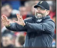 ?? — Reuters ?? Have a belly laugh: Liverpool’s hattrick hero Roberto Firmino celebratin­g with the ball tucked under his shirt after the 5-1 thrashing of Arsenal in the English Premier League match at Anfield on Saturday. Below: Juergen Klopp is keeping his players grounded.