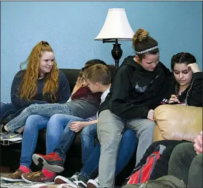  ??  ?? Ranchers pile up on a couch at the ranch after arriving from school.