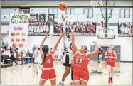  ?? Tim Godbee ?? Calhoun sophomore guard Saniah Dorsey puts a shot up over a pair of Dalton defenders during the team’s regular season finale Friday night at The Hive. They won 61-42 to clinch the top seed in this week’s Region 7-5A tournament.