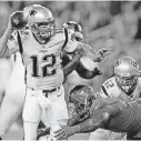  ?? PHOTO] [AP ?? New England Patriots quarterbac­k Tom Brady looks to throw a pass as he is pressured by Tampa Bay Buccaneers defensive end Robert Ayers during the first half of Thursday’s game in Tampa, Fla.